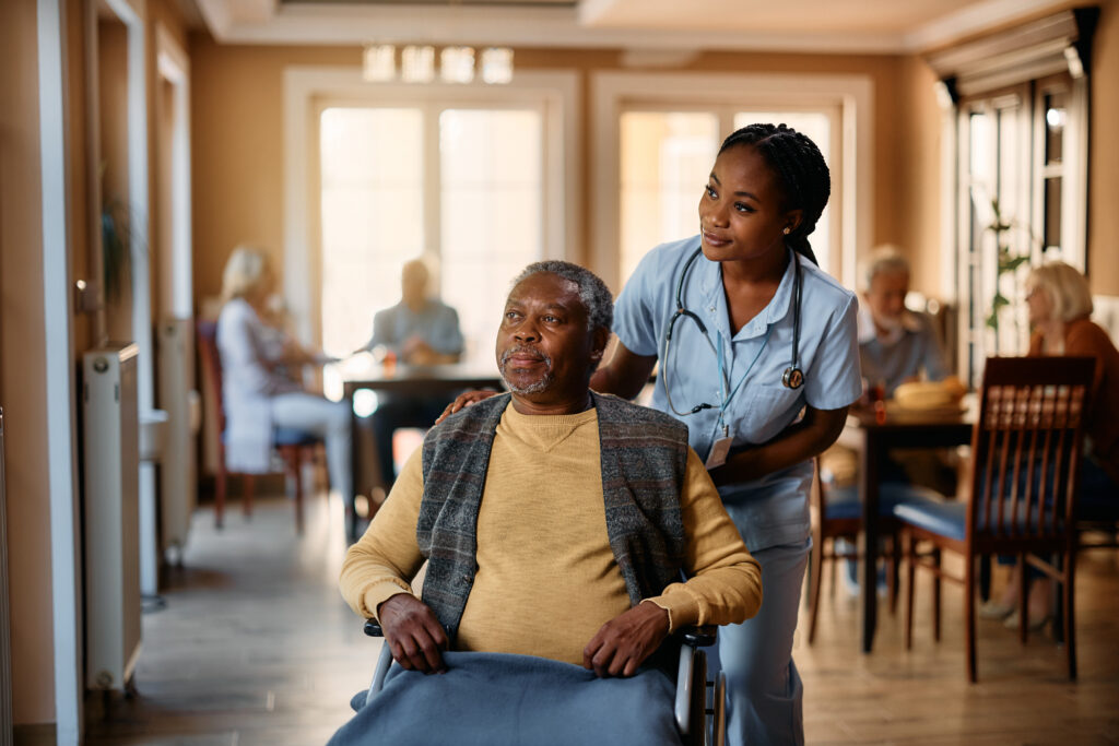 Nursing home nurse and patient in wheelchair