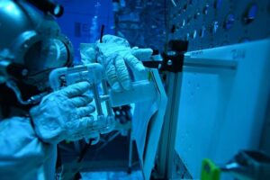 A NASA diver performs an underwater test of a tool designed by Florida Polytechnic University students to be potentially used for repairs outside the International Space Station. Image courtesy of NASA